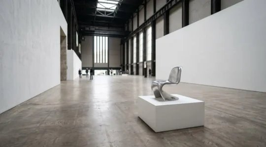 Contemporary gallery space showcasing design objects as fine art installations in modern British museum context